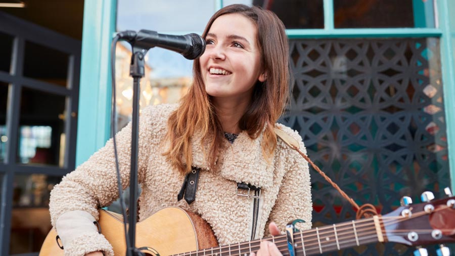 girl guitarist playing song 