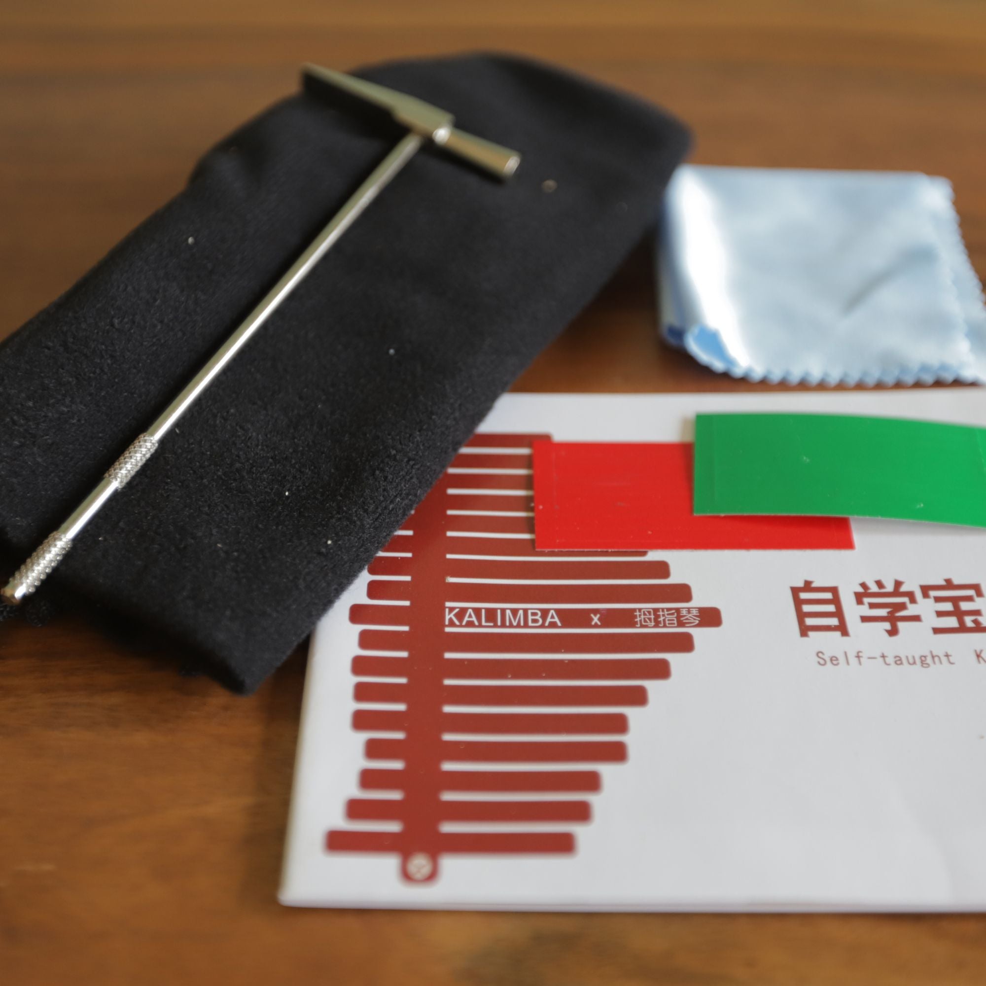 Microfibre cloth, soft kalimba bag, note stickers, tuning hammer and a kalimba book with tabs