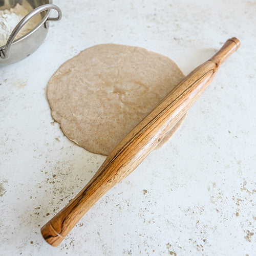 Traditional Chapati Rolling Pin with Freshly Rolled Chapati