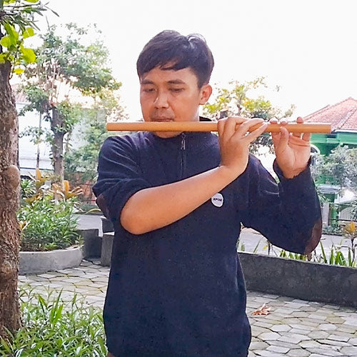 Maulana Malik Ibrahim playing the traditional Indonesian flute