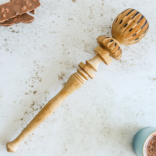 Molinillo whisk on a white background