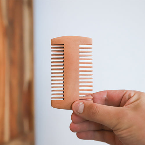 pear wood comb in hand