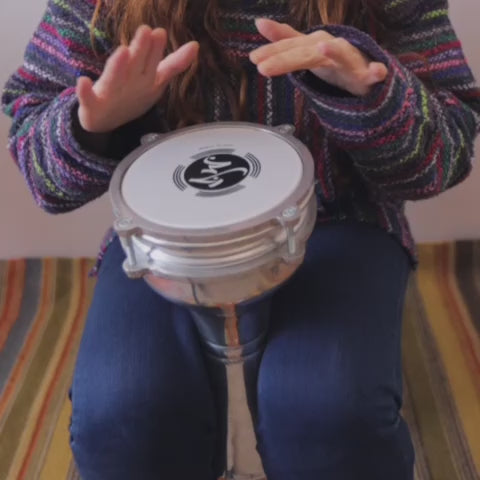 Women playing basic drum pattern on Turkish darbuka drum